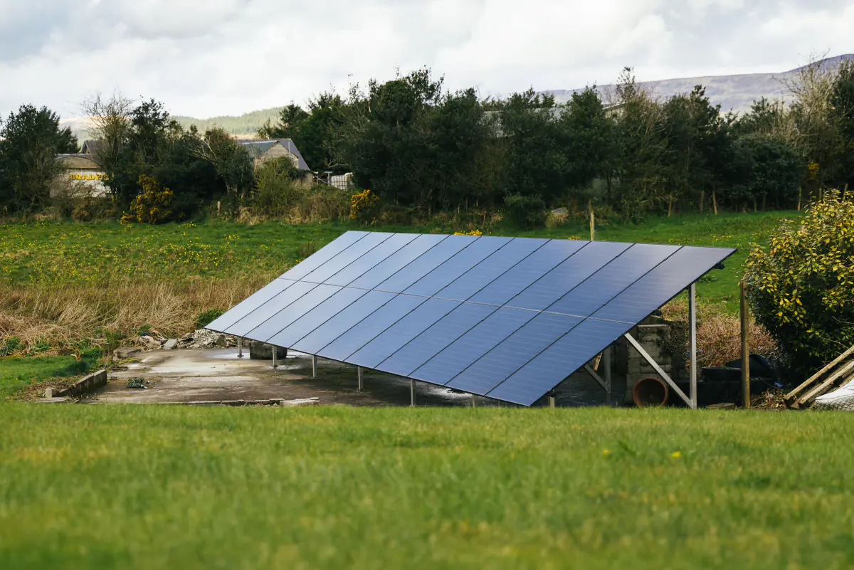 Wide ground-mounted solar PV array installed in a rural Cork field.