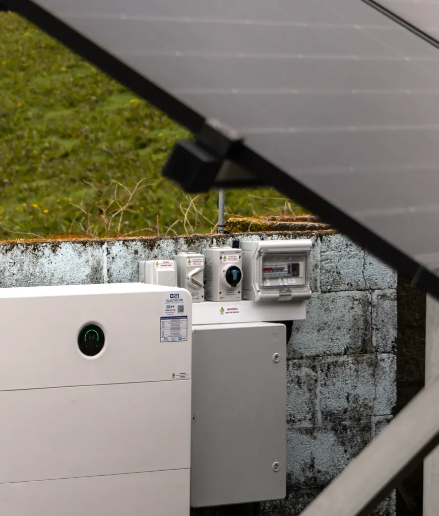 Solar battery and electrical control equipment installed below ground-mounted solar panels.