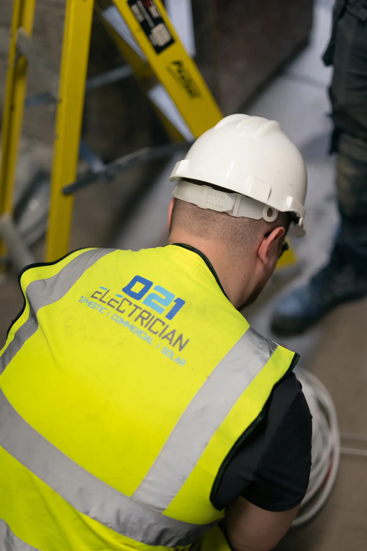 021 Electrician team member working near cables and commercial electrical equipment in Cork.