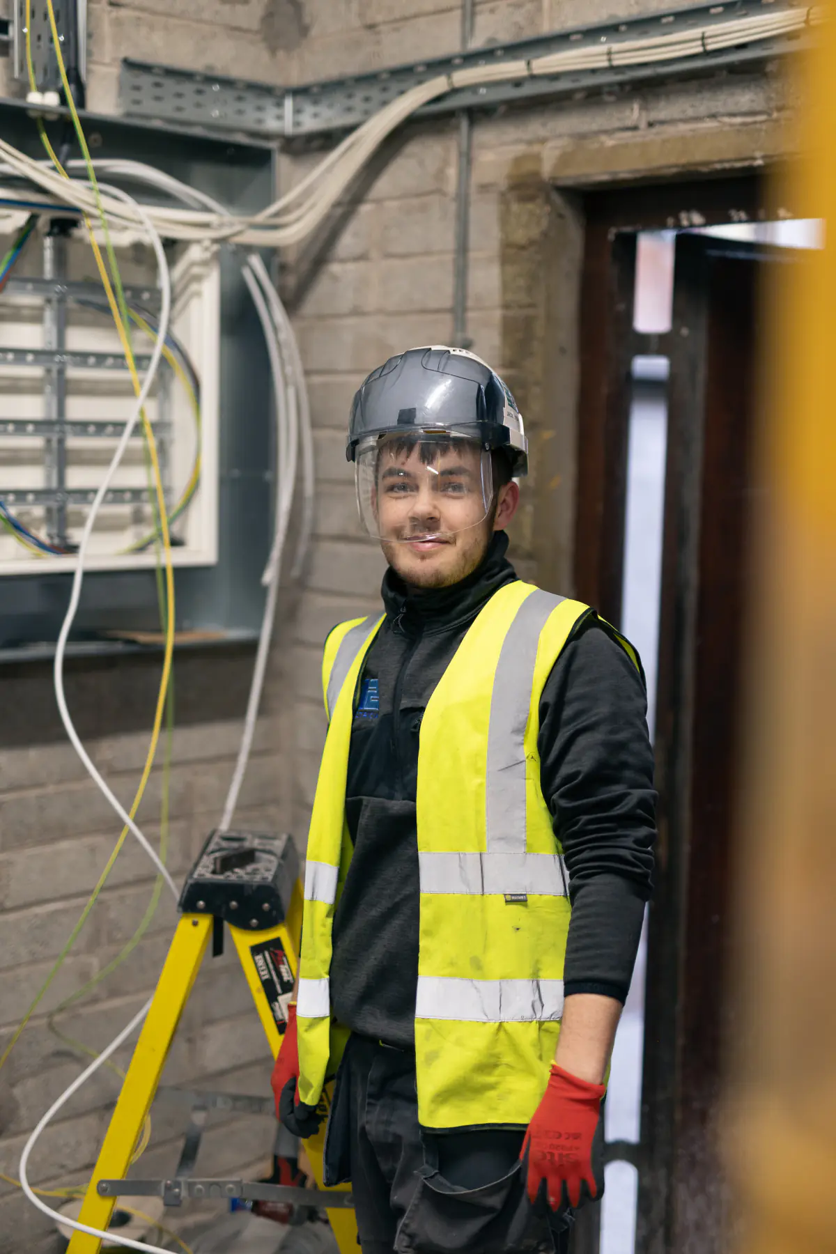 021 Electrician team member wearing safety gear during commercial electrical work in Cork.