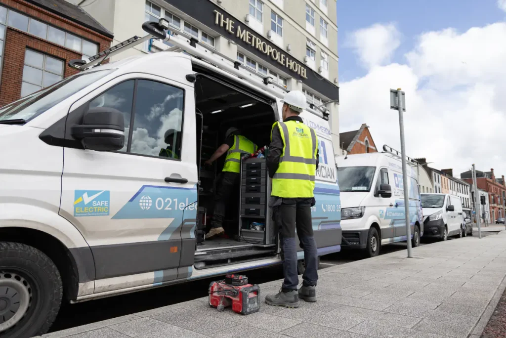 021 Electrician branded service vans parked outside The Metropole Hotel Cork.